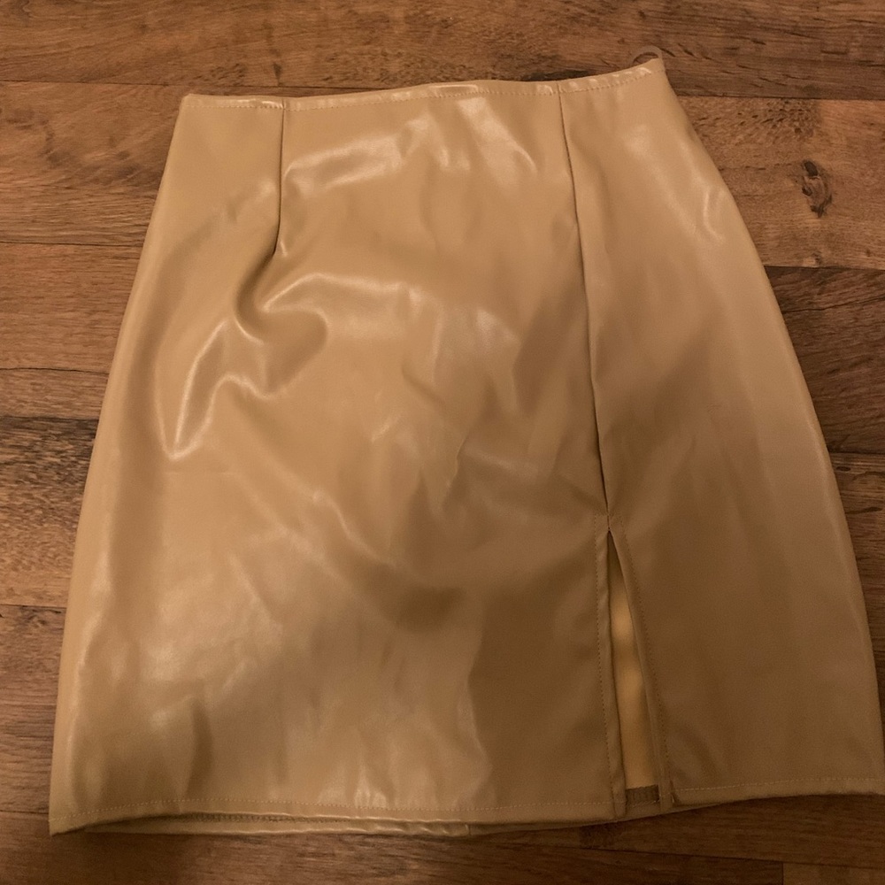 Pleather tan skirt with slit in the front. Size XS. Very form fitting